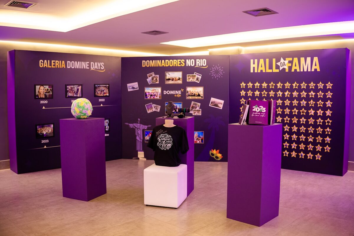 Instalação cenográfica com galeria e mobiliário em evento — a distribuição de zonas reduz a interferência sonora